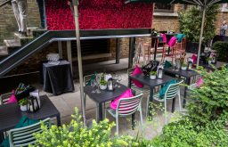 outdoor event space, wine glasses on outdoor tables, drinks reception