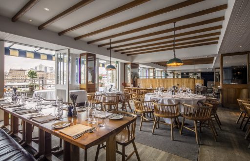 restaurant, doors opening to outdoor area, round tables