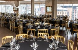 conference room, glasses, golden chairs, black tables