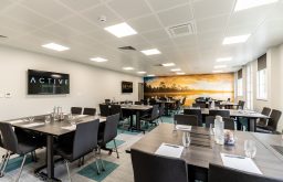 sunset feature wall, classroom layout, water bottles and glasses, two TV screens