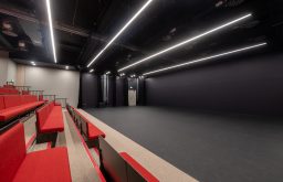 auditorium ,red chairs, stage area, conference space