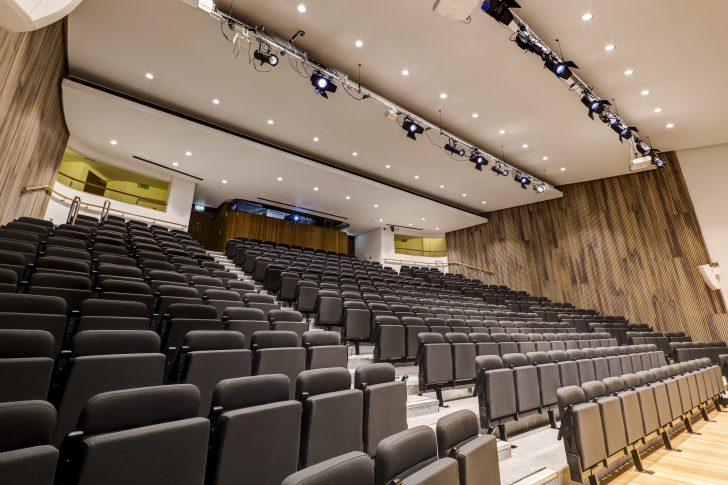 modern auditorium chairs, railings on the side, accessible, conference space