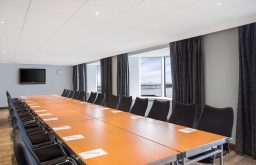 boardroom layout, plasma screen, natural daylight, large meeting room