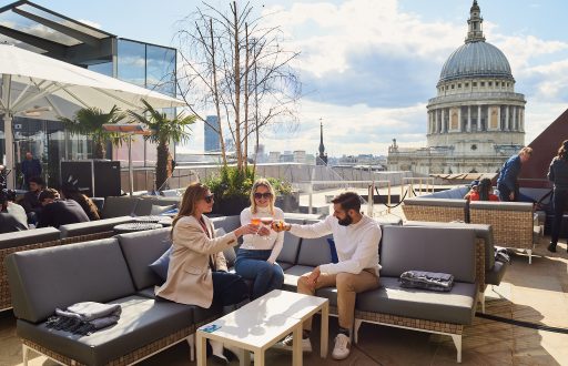 roof terrace, summer drinks reception, people sitting down on outdoor chairs