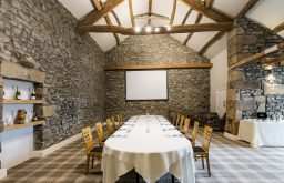 projector screen, boardroom, cobblestone walls, historic