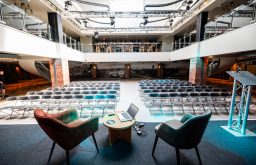 stage with two chairs for conference speaker, conference space, theatre style, lecturn